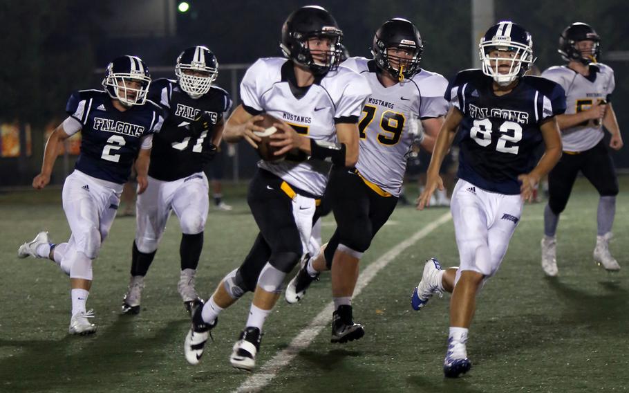 American School In Japan quarterback Jack Ambrosino runs the ball around right end against Seoul American during Saturday's game. The Mustangs blanked the Falcons 35-0.