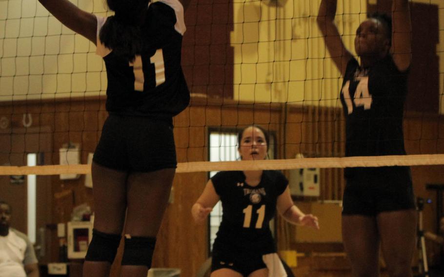 Matthew C. Perry's Asia Walker and Zama's Tasia Nelson battle at the net as Trojans teammate Cameron Baker looks on during Saturday's volleyball match. Zama won in straight sets.
