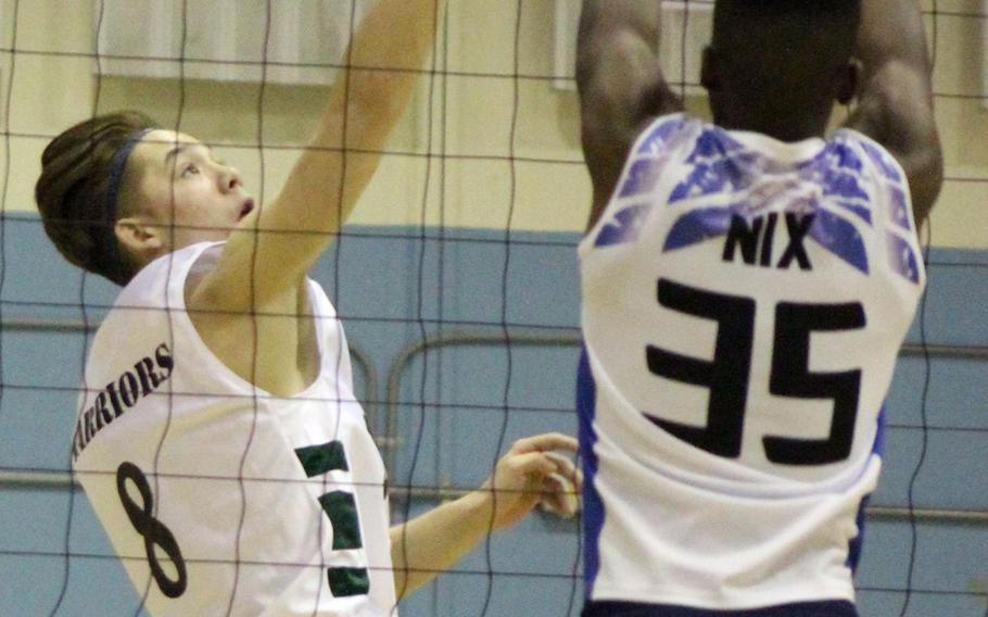 Daegu's Hunter Lane puts up a shot against the block of Seoul American's Josh Nix during a volleyball match at Falcon Gym Friday, Oct. 7, 2016. 

