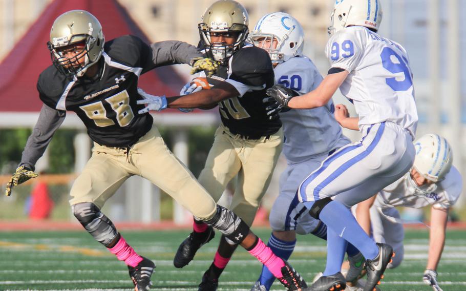 Humphreys' Braxton Long gets a block from Tyrell Alexander as he takes an interception upfield.