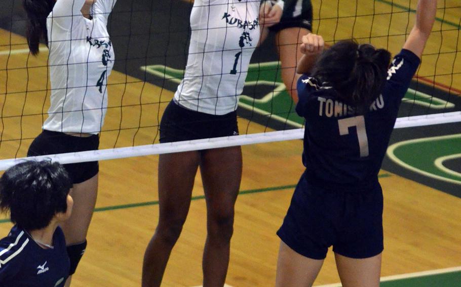 A Tomishiro player tries to spike through the double block of Kubasaki's Mimi Larry and Alanna Stein during Saturday's Okinawa Columbus Day Weekend Volleyball Festival at Kubasaki High School. The Dragons went 4-2 in pool play and beat Kitanakagusuku in the third-place match 25-6, 25-16.