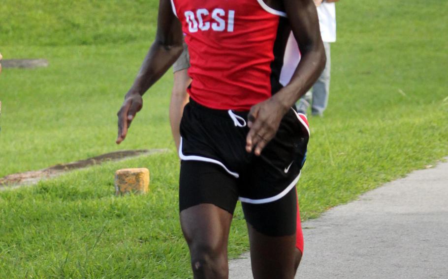Okinawa Christian's Tony Wachira crosses the finish line first in 17 minutes, 42 seconds to win Wednesday's boys race at Kadena.