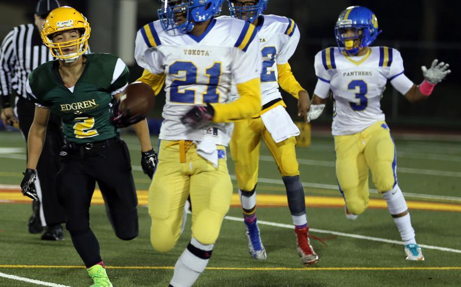 Yokota's Marquis Smith-Brown dashes upfield away from Edgren's Raphael Lykins.