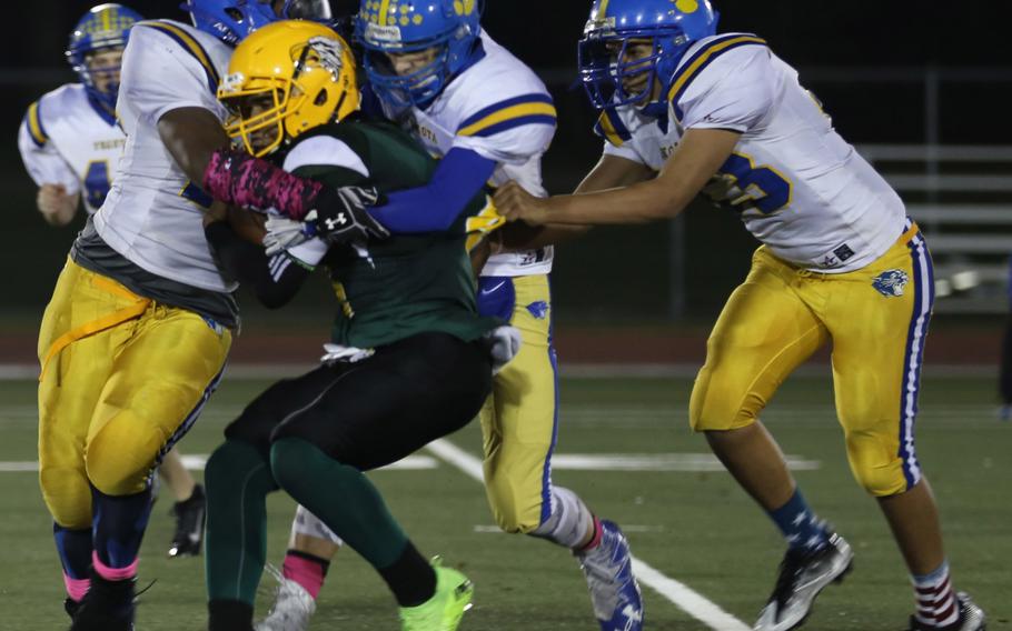 Robert D. Edgren quarterback Patrick Sledge is surrounded by Yokota defenders.