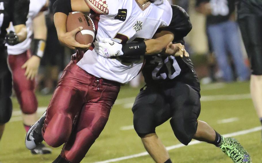 Matthew C. Perry's Andrew Borrero tries to shrug off the tackle of Zama's Anthony Ames.