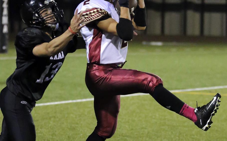 Matthew C. Perry's Dylan Ernst intercepts a pass in front of Zama receiver Curtis Blunt.