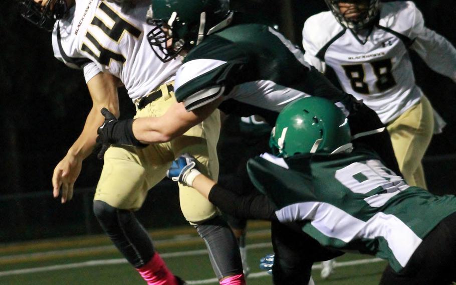 Humphreys running back Miles Brice drags Daegu defenders William Bair and Michael Bobadilla with him.