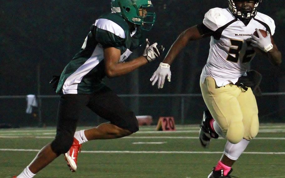 Daegu's Keith Williams homes in on Humphreys running back David Key.