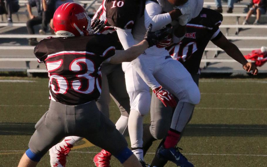 Nile C. Kinnick's Devoney Stanley and Seoul American's Levi Johnson go up for a pass.