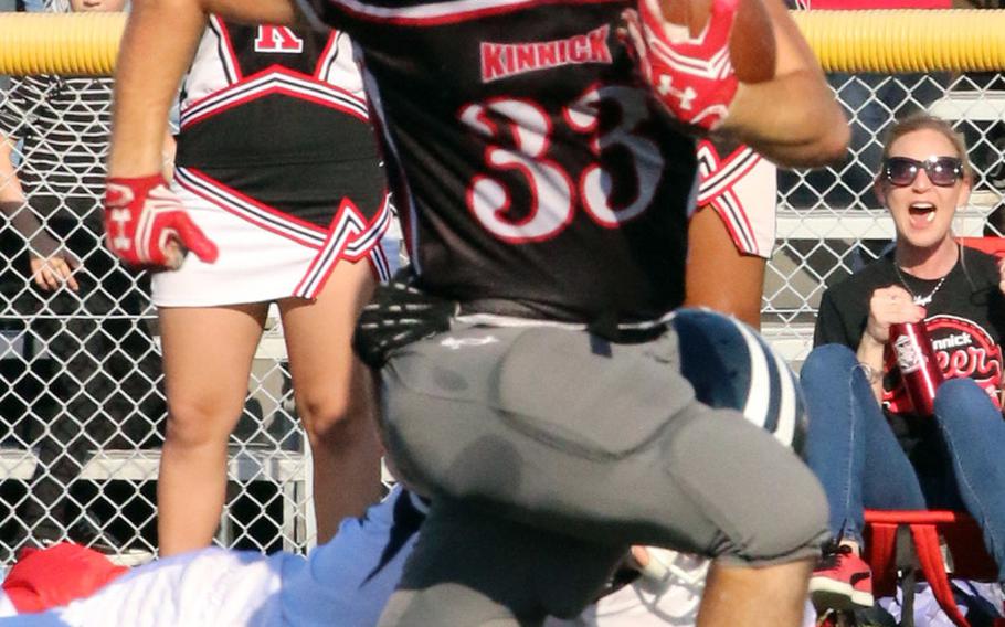 Nile C. Kinnick's Connor Joley races upfield with an interception return against Seoul American.