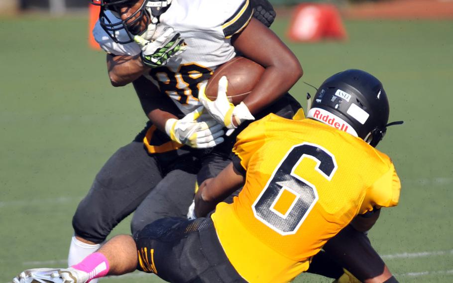 Kadena tight end Abe Patterson gets wrapped up by American School In Japan defenders Jo Tsusaka and Sho Hatakeyama.