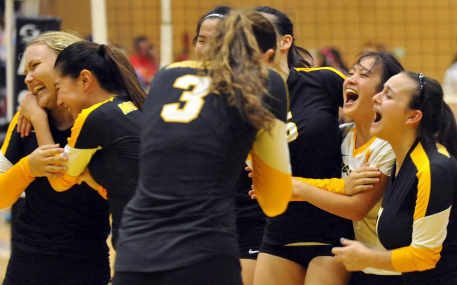 American School In Japan players celebrate following Saturday's final match in the ASIJ-YUJO volleyball tournament. The Mustangs rallied from two sets down to beat the defending champion Dragons in five sets.