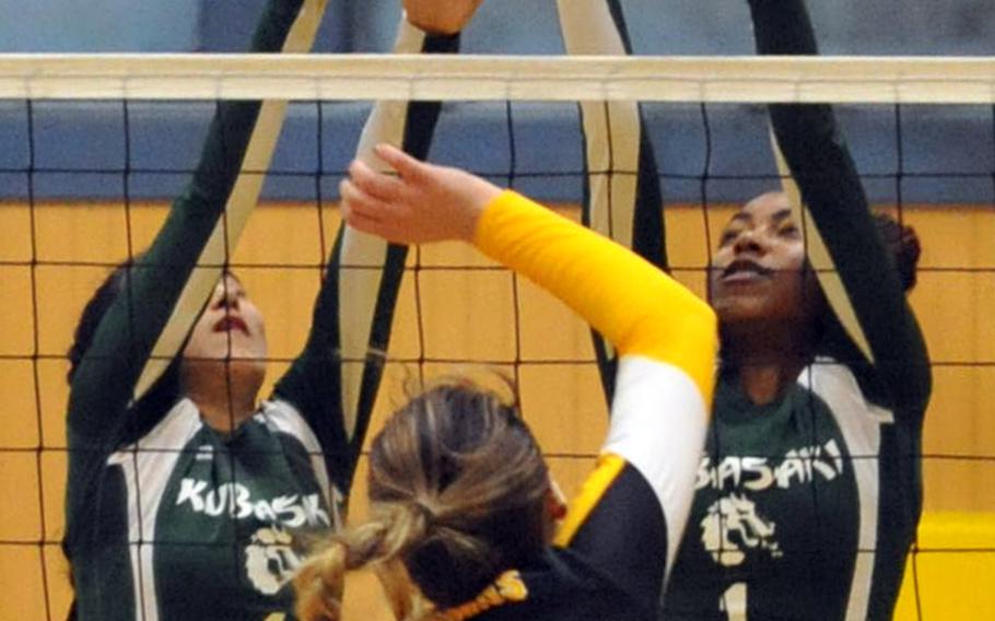 Kubasaki's Mimi Larry and Alanna Stein go up to try to block a spike by American School In Japan's Savannah Napierski during Saturday's final of the ASIJ-YUJO Volleyball Tournament. The Mustangs rallied from two sets down to beat the defending champion Dragons in five sets.