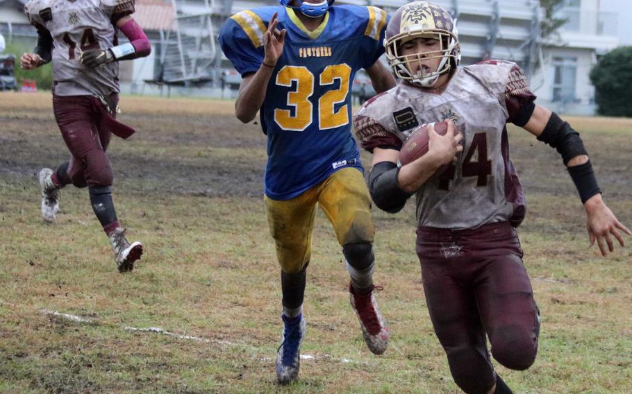 Matthew C. Perry senior running back Caeleb Ricafrente races ahead of Yokota defender C.J. Thomas toward the end zone as Samurai quarterback Garrett Macias watches.