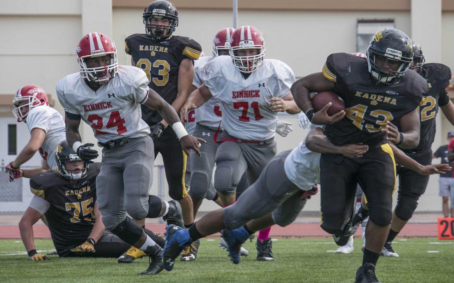 Kadena running back Uriah Morris drags one Nile C. Kinnick defender and leaves a heap of others in his wake.