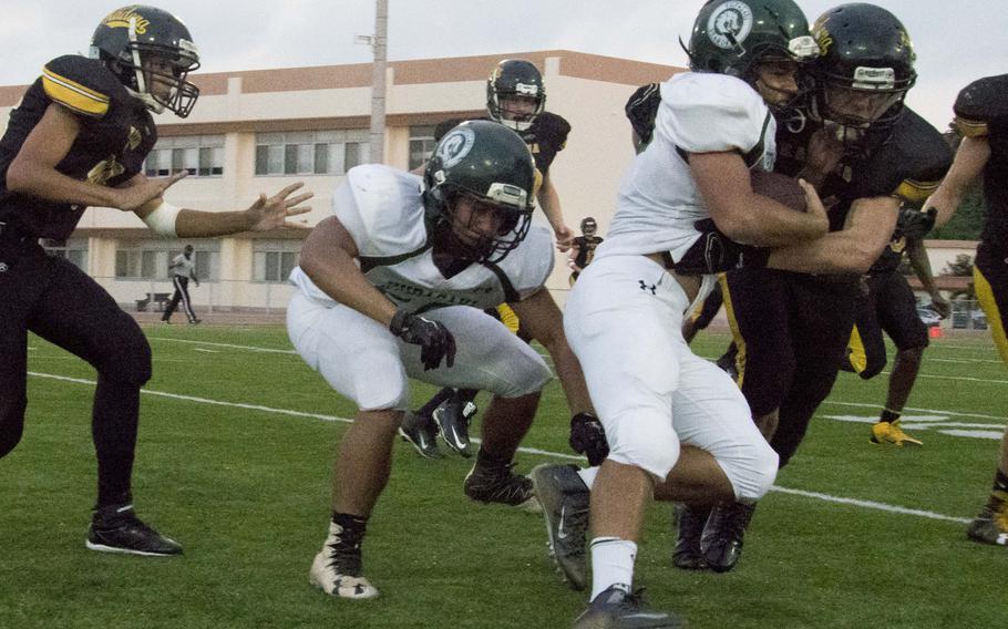 Kubasaki's Abe Patterson carries the ball into the Kadena defense on Thursday in the Dragons' 47-20 loss to the Panthers.