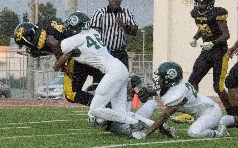 Kubasaki's Juan Guerro tackles Kadena's Uriah Morris on Thursday in the Panthers' 47-20 victory over the Dragons - the third time in as many games that Kadena has beaten Kubasaki this season.