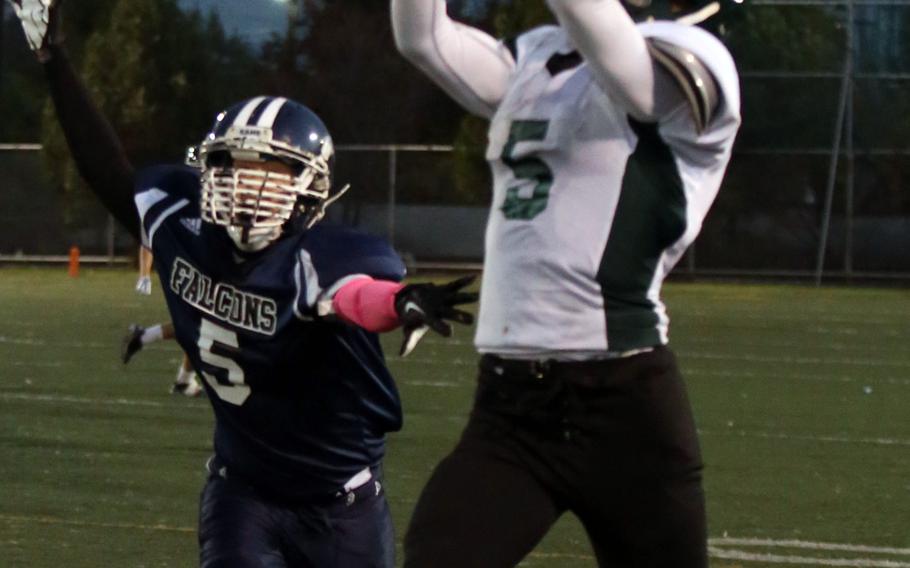 Daegu's William Bair leaps high for a pass over Seoul American's Jonathan Gibson. The Warriors won 18-8.