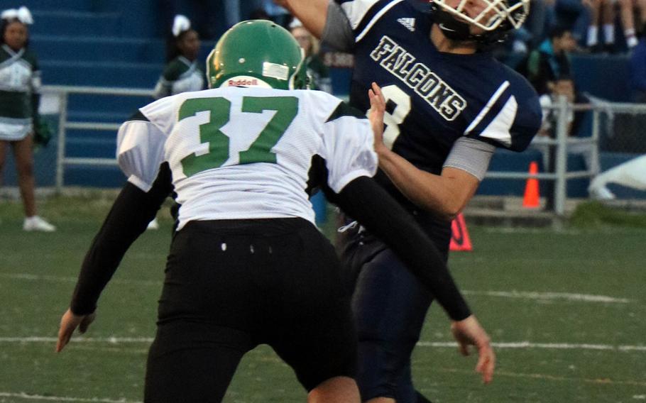Daegu's Mitchel Champaco draws a bead on Seoul American quarterback David Messinger. Champaco's Warriors beat the Falcons 18-8 in Friday's game.
