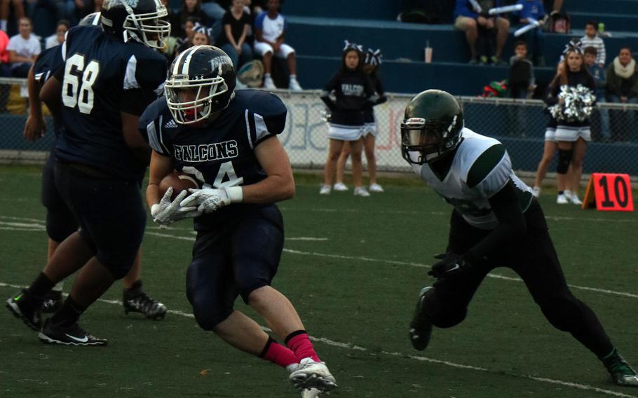 Seoul American running back Wayne White runs for daylight during Friday's game. He scored a two-point conversion in a losing cause as Daegu beat the Falcons 18-8.