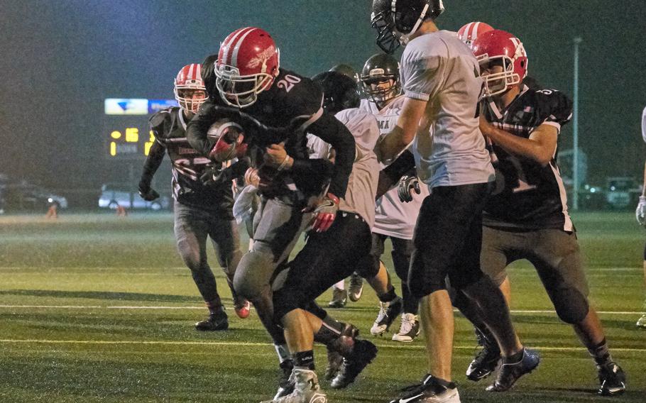 Kinnick running back Harry Cheng breaks a tackle to get in the end zone in the first half of the Red Devils' 45-6 homecoming win over Zama on Friday, Oct. 28, 2016 at Naval Base Yokosuka, Japan. The win also sealed the school's first Kanto Plain championship in 18 years and their third DODEA-Japan title in four years.   