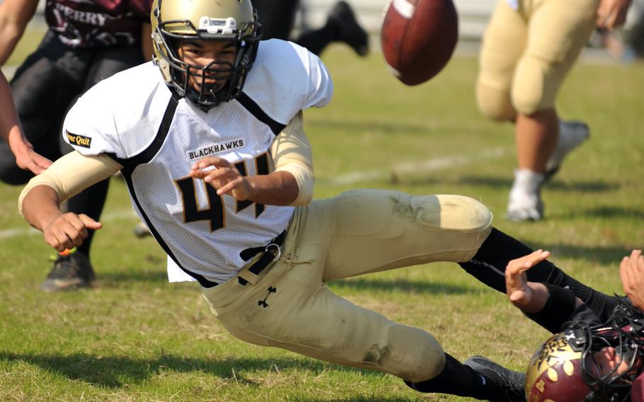 Humphreys running back Miles Brice loses his purchase and his handle on the football, one of two turnovers by the Blackhawks.