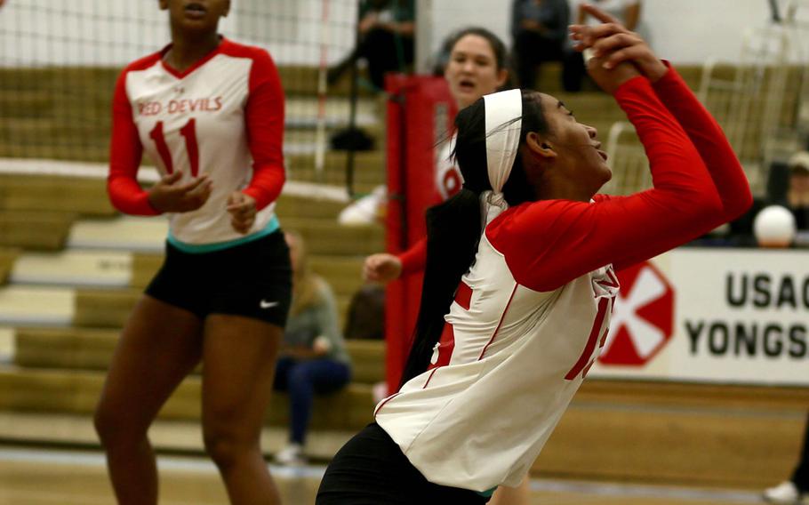 Nile C. Kinnick's Exotica Hall keeps the ball alive against Kubasaki during Monday's round-robin match in the Far East Division I Volleyball Tournament. The two-time defending champion Dragons beat the Red Devils 25-11, 25-17.