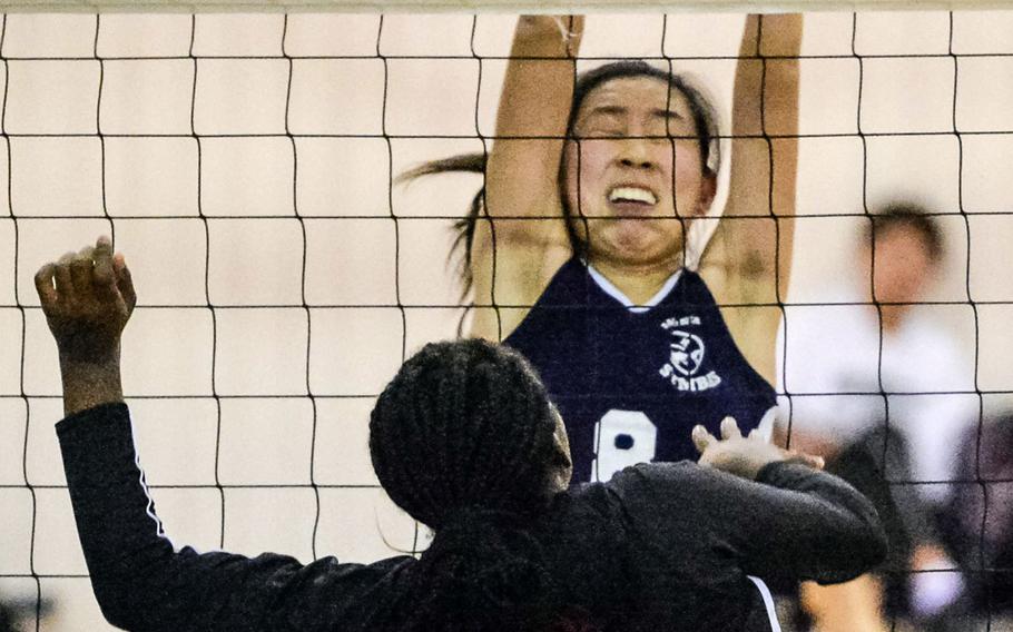 Sacred Heart's Risa Sato blocks E.J. King's Jameira Petty during Tuesday's pool-play match in the Far East Division II volleyball tournament. The defending champion Symbas outlasted the Cobras 25-20, 18-25, 25-17, 25-14.