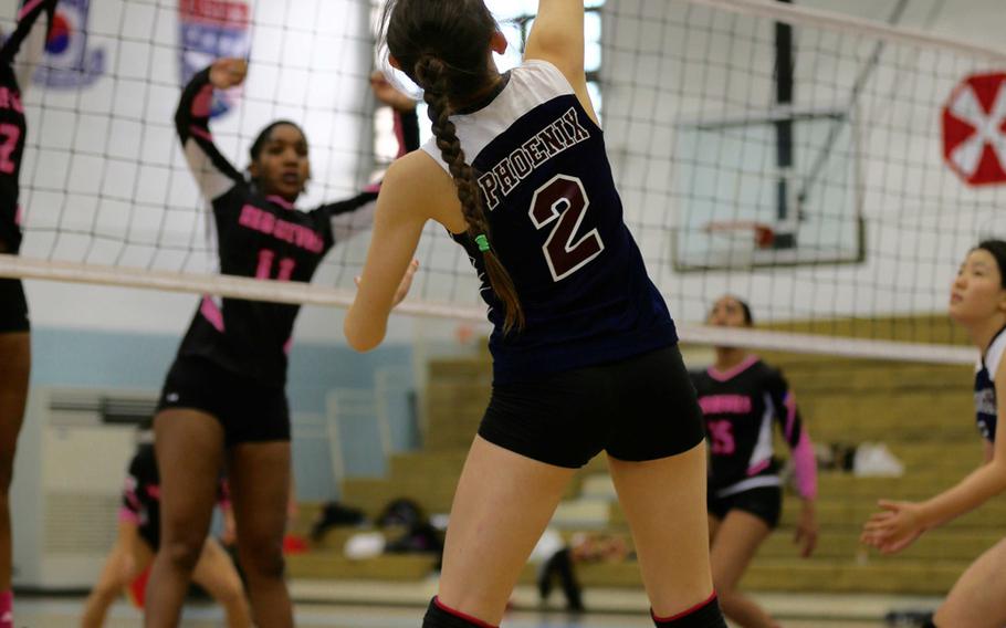 Seisen's Kathleen Martens looks for a hole in the Nile C. Kinnick defense during Tuesday's round-robin play in the Far East Division I volleyball tournament. The Red Devils outlasted the Phoenix in three sets, 25-19, 28-30, 25-19.