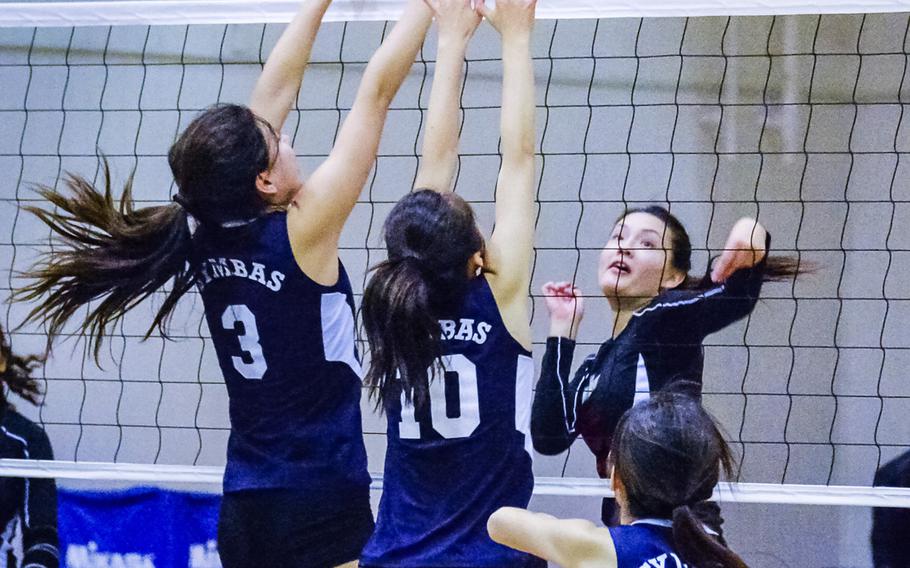 E.J. King's Ayumi Murphy attacks Sacred Heart defenders, from left, Nina Warita,  Rachael Graham and Mia Korver at the 2016 Far East Division II Volleyball Tournament at Yokota Air Base, Japan Wednesday, Nov. 9, 2016. King fell 25-8, 25-15, 25-11 dropping the Cobras to a seventh-place match against Edgren Thursday. 