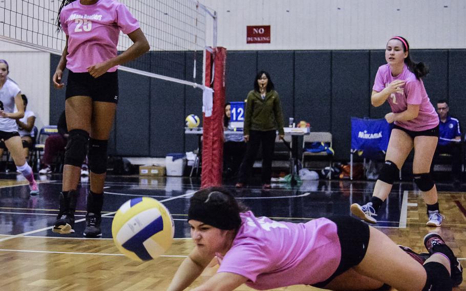 Yokota's Irene Diaz digs out a scoring chance as teammates Britney Bailey, left, and Sally Lambie watch at the 2016 Far East Division II Volleyball Tournament at Yokota Air Base, Japan Wednesday, Nov. 9, 2016. The hosts defeated Zama 23-25, 23-25, 26-24, 25-18, 15-10 sending the Panthers to the championship for the right to win their first Far East volleyball title against Christian Academy of Japan.  