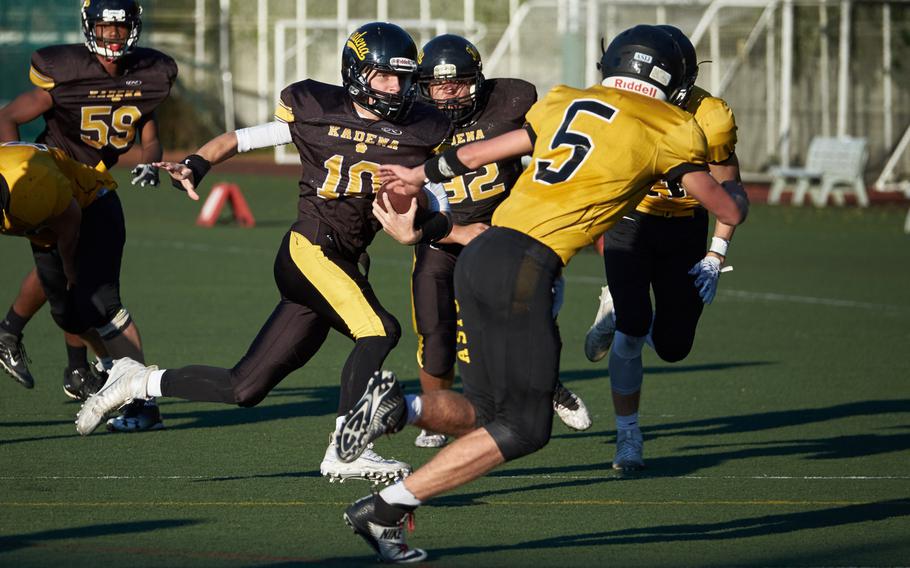 Kadena quarterback Cody Sego breaks out of the pocket as ASIJ's Jack Ambrosino gives chase during the Far East Division I Football Championship on Saturday at the American School in Japan in Chofu, Japan. ASIJ defeated Kadena 35-18 to claim its first Far East Football crown. 