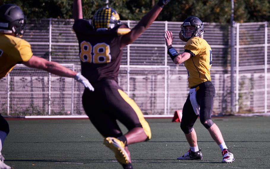 ASIJ quarterback Jack Ambrosino looks for a receiver as Kadena's Abe Patterson comes around the edge during the second quarter of the Far East Division I Football Championship on Saturday at the American School in Japan in Chofu, Japan. ASIJ defeated Kadena 35-18 to claim its first Far East Football crown. 