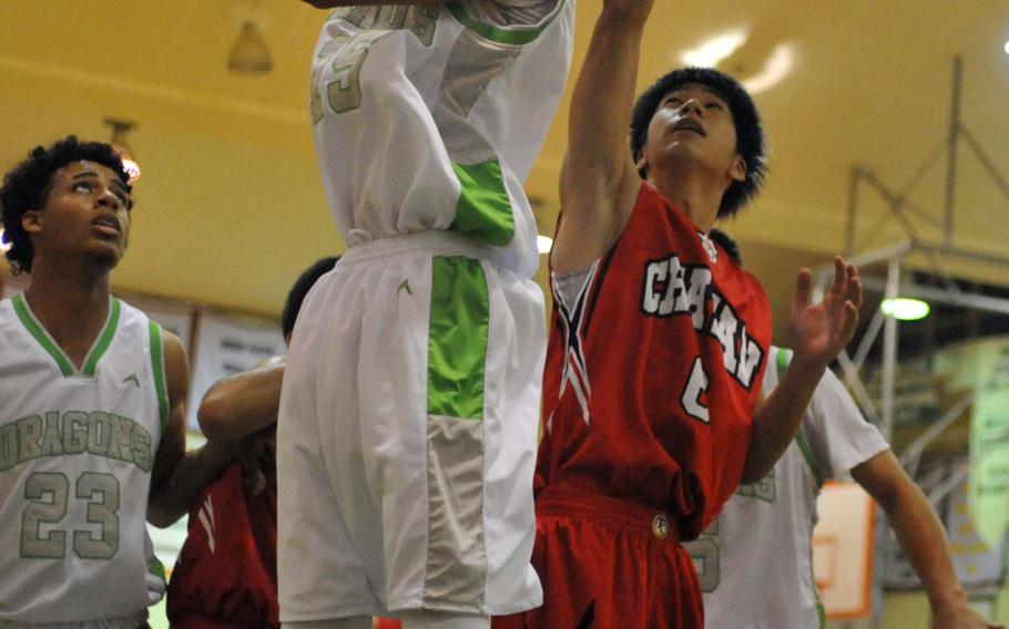 Kubasaki junior center Ilijah Washington goes up for a reverse layup Friday during the Dragons' 86-59 season-opening home win over Chatan.