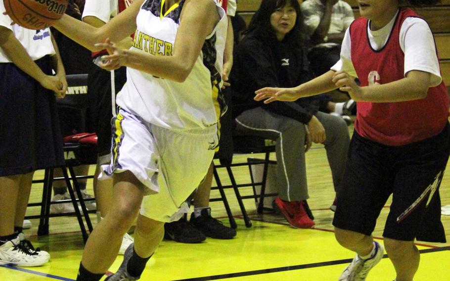 Kadena Panthers forward Isabel Tayag drives to the basket against the Futenma Red Braves during Monday's girls basketball game. Tayag, a junior transfer from Robert D. Edgren, was in the starting lineup. Defending Far East Division I champion Kadena fell 54-44.