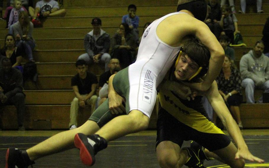 Kadena's Shaun Freeman tries to lift Kubasaki's Connor Brennan during Thursday's 129-pound bout in the season-opening dual meet. Freeman won by technical fall 10-0 in three minutes.