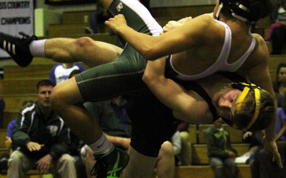 Kadena's Kaleb Wallace tosses Kubasaki's James Carpenter with a side suplex during Thursday's 122-pound bout in the season-opening dual meet. Wallace won by technical fall with two four-point throws.