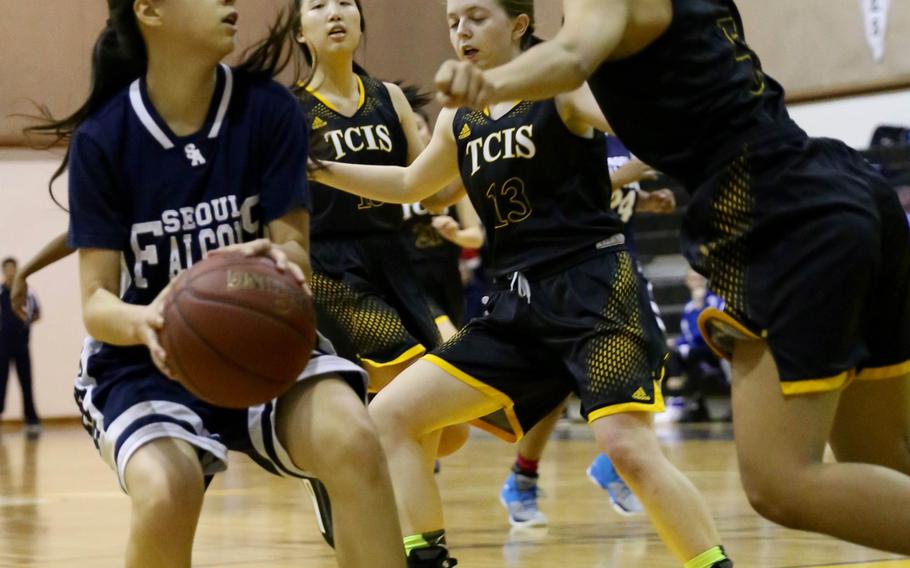 Seoul American guard Maria Bruch finds herself hemmed in by three Taejon Christian defenders during Friday's girls basketball game, won by the Falcons 41-26.