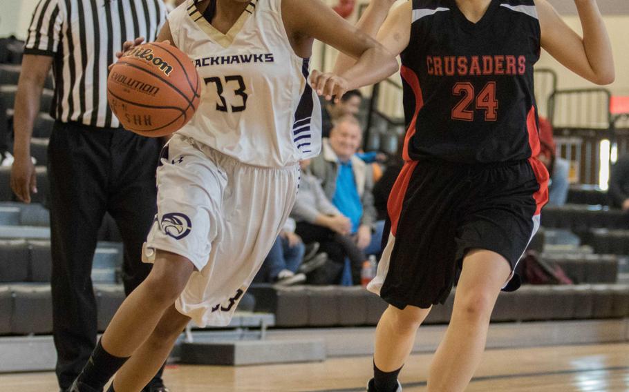 Humphreys' Jaedyn Jones drives to the basket against Seoul Foreign's Janet Lee during Saturday's girls basketball game, won by the Crusaders 32-27.