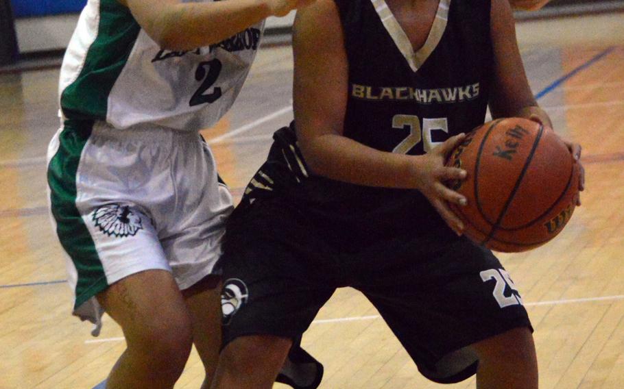 Cleopatra Cody of Humphreys looks for operating room against Daegu's Ki'inani Royer during Wednesday's girls basketball game.  Blackhawks won 34-16.