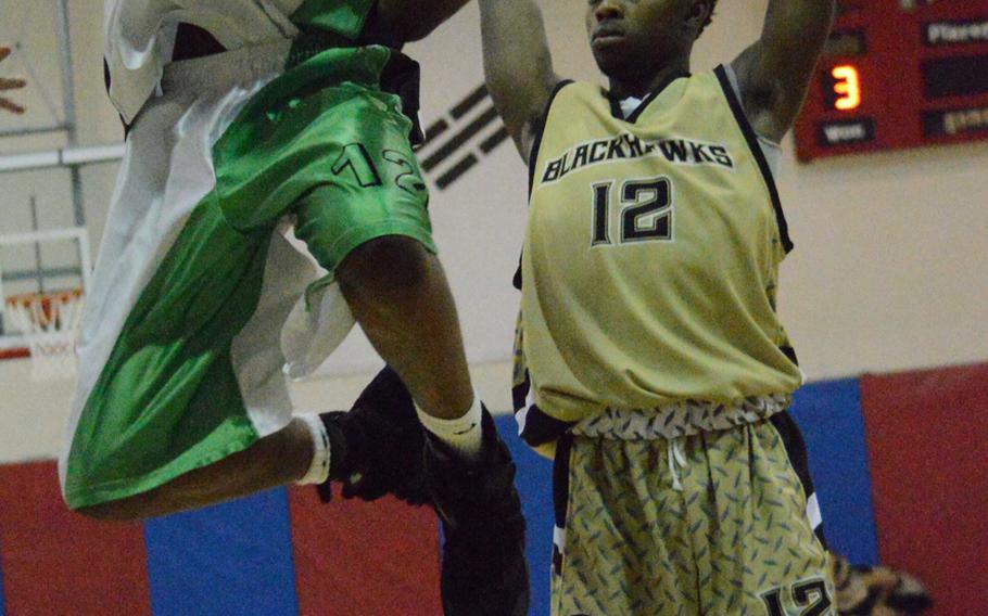 Keith Williams of Daegu goes up for a shot against Da'Shun Cline of Humphreys during Wednesday's basketball game, won by the Blackhawks 43-28.