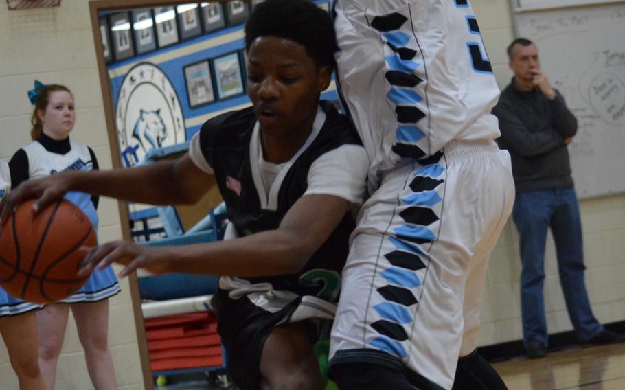 Daegu's Kevin Williams tries to dribble past Osan's Justin Maglalang during Saturday's boys basketball game, won by the Cougars 61-30.