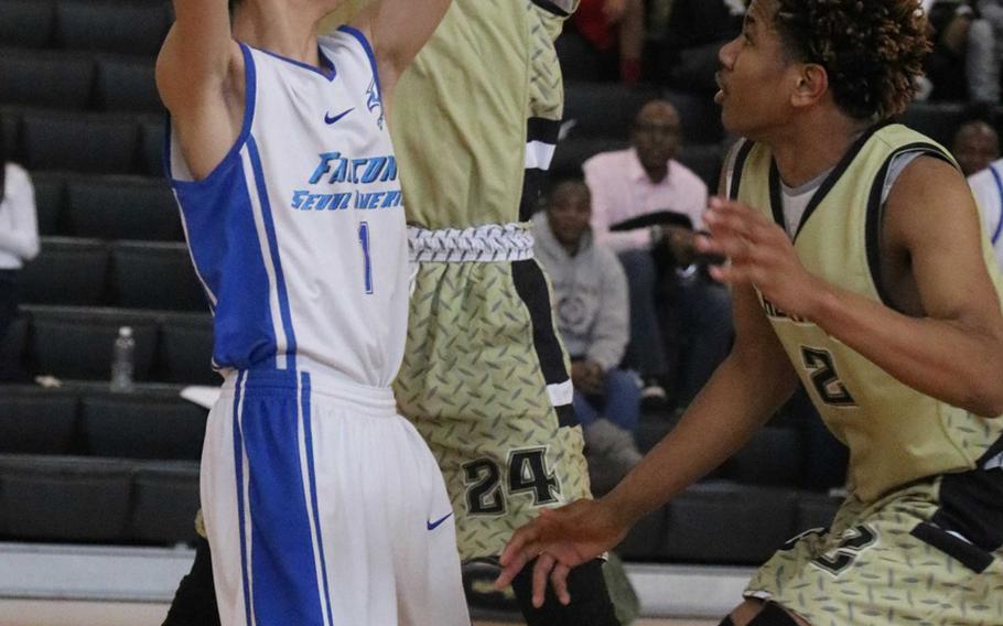 Seoul American's Caleb Lee is hemmed in by Humphreys defenders Brice Bulotovich and Tyrell Alexander during Saturday's boys basketball game. The Blackhawks beat the Falcons for the third straight regular-season game 67-41.