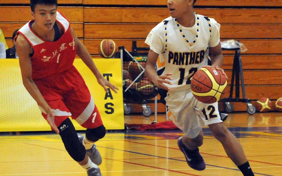 Kadena's Anthony Laney dribbles against a Yilan defender during Saturday's boys game in the 2nd Taipei American School Basketball Exchange. The Panthers lost for the first time in six games they've played in Taipei, 80-77 to Yilan, a local Chinese team.