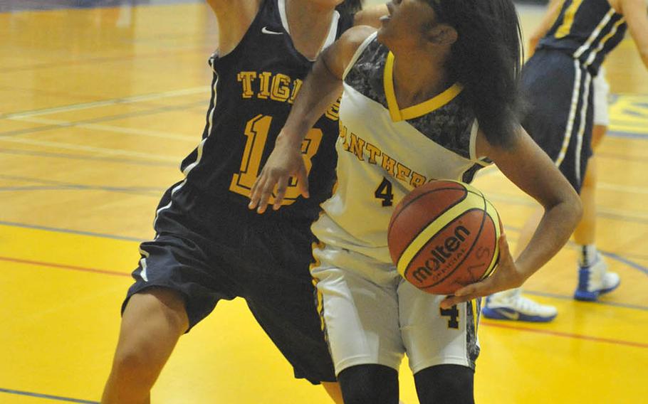 Kadena's Rhamsey Wyche looks for room against the Taipei American defense during Saturday's girls game in the 2nd Taipei American School Basketball Exchange. The Panthers lost to the host Tigers 53-46, their first loss in their first five games played in Tapiei the last two Januarys.