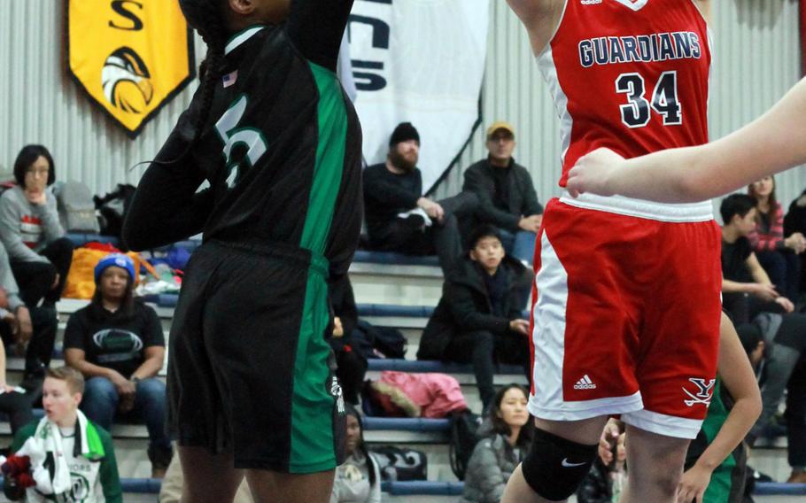 Yongsan's Rachael Ko shoots over Daegu's Kennedi Williams during Saturday's girls basketball game, won by the Guardians 38-4.