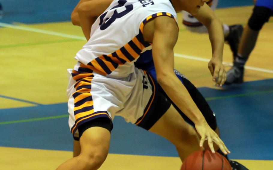Guam High's Raven Taitague dribbles against the St. Paul Christian defense during Saturday's boys basketball game. The Warriors edged the Panthers 68-63 in overtime.