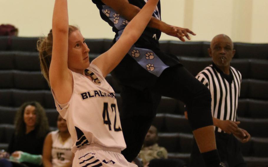 Osan's Danielle Dawson skies over Humphreys' Kaelin Elliott for a shot during Wednesday's girls basketball game. The visiting Cougars won 51-25.