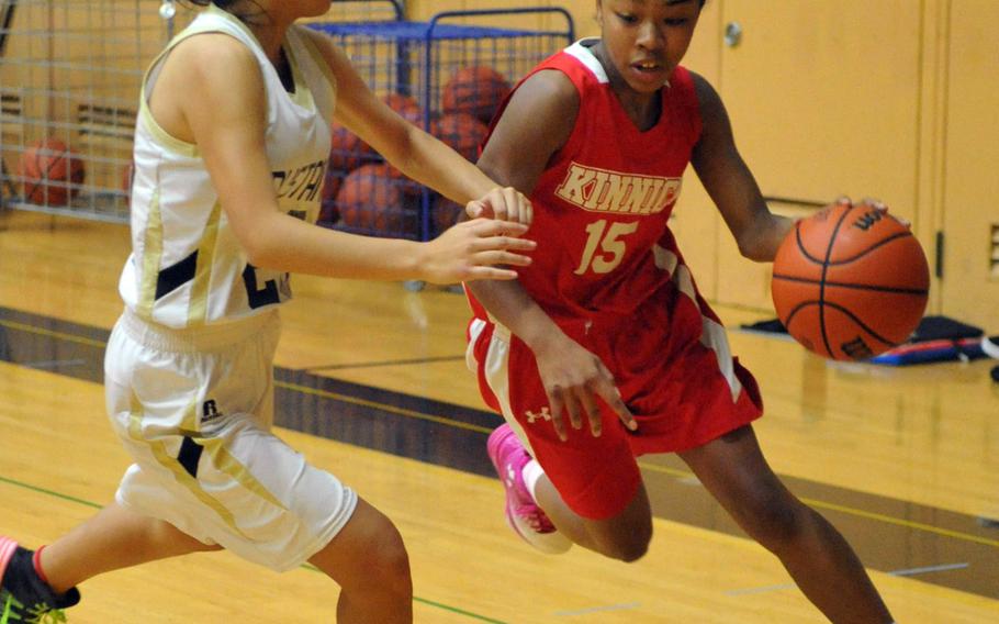 Nile C. Kinnick's Venus Hill tries to dribble past American School In Japan's Erin Chang on Day 2 Friday of the 1st ASIJ Kanto Classic. The Mustangs downed the Red Devils 38-26 and earned the top seed in Saturday's single-elimination playoffs.