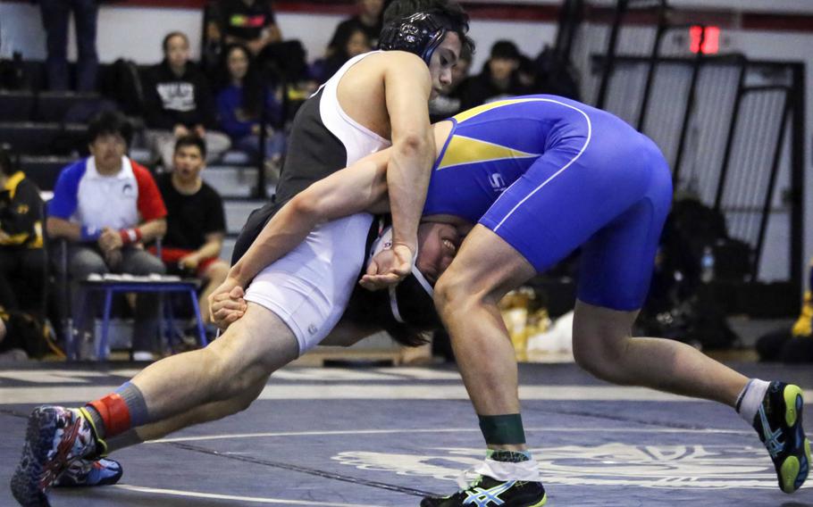 Zama's Curtis Blunt and Jihoon Seo of St. Mary's tangle in the 148-pound championship during Saturday's Zama Invitational. Blunt captured first place and Seo placed second.